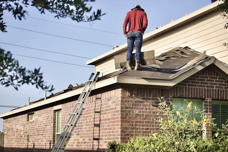 Professional roofer working on a residential roof in Greendale Estates